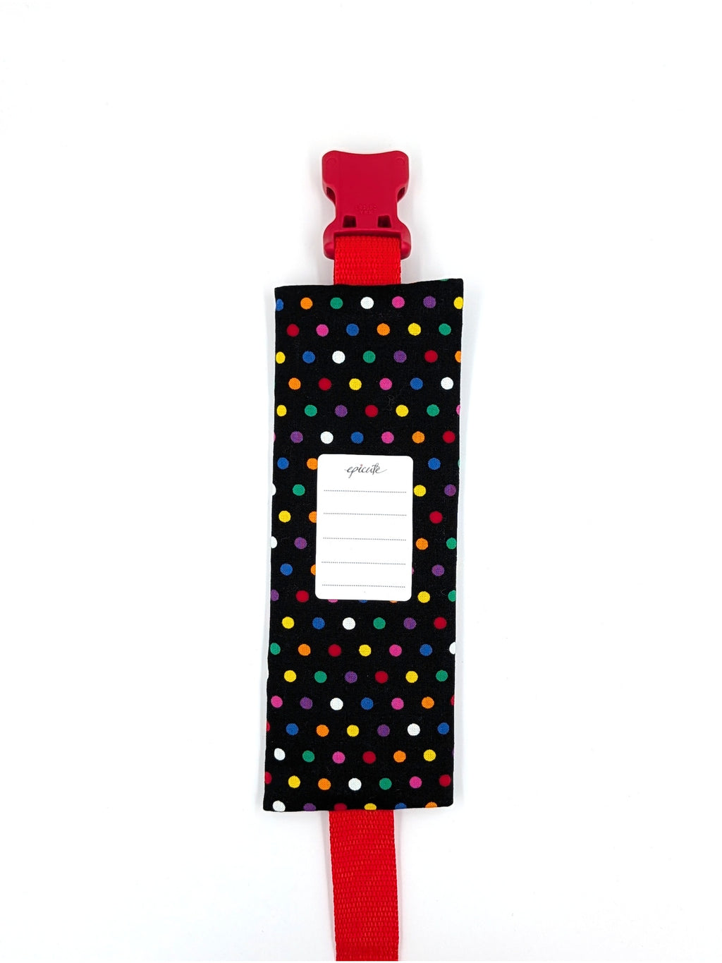 The Daydreamer EpiPen pouch in a black confetti dot print with the red adjustable belt, back view, showing the care label