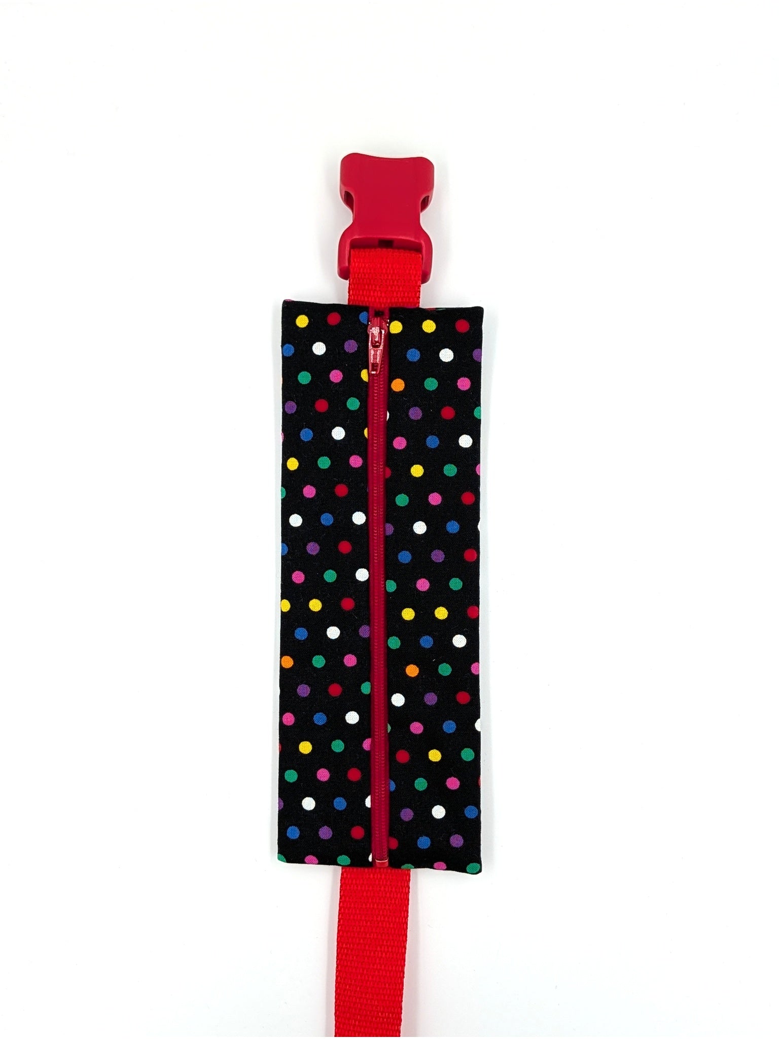 The Daydreamer EpiPen pouch in a black confetti dot print with the red adjustable belt, closed