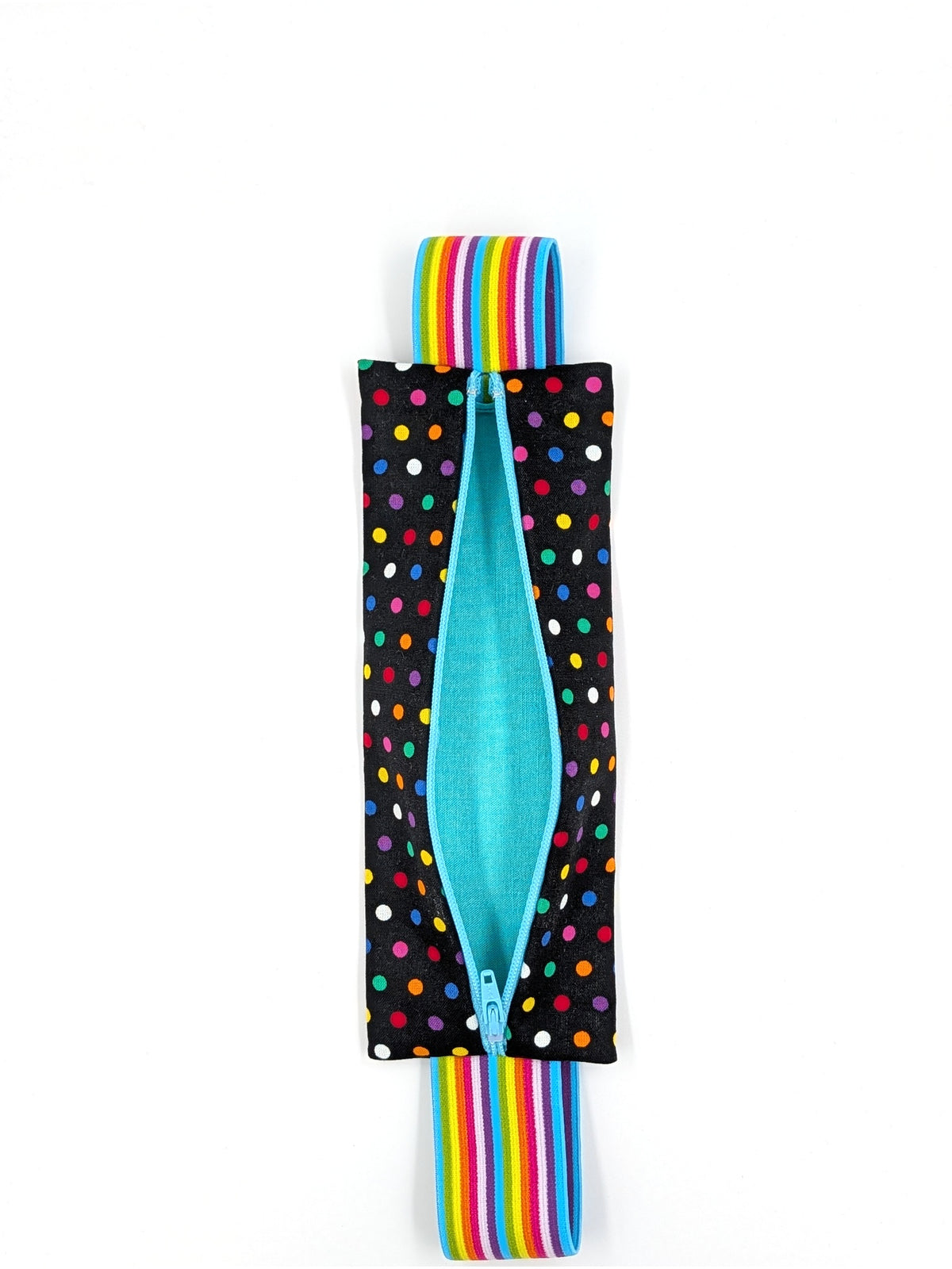 The Daydreamer EpiPen pouch in a black confetti dot print with the rainbow elastic strap, unzipped and empty, showing the teal liner