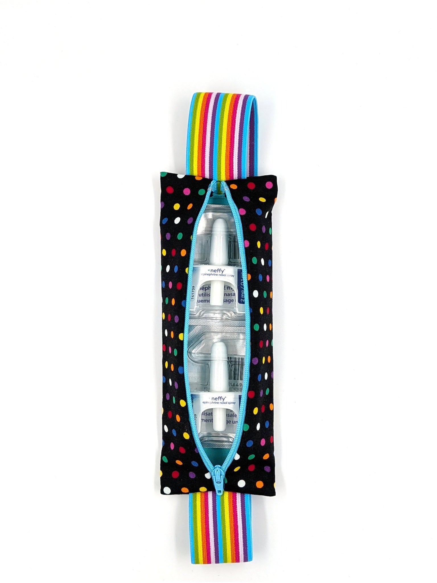 The Daydreamer EpiPen pouch in a black confetti dot print with the rainbow elastic strap, open with two neffy nasal spray doses inside