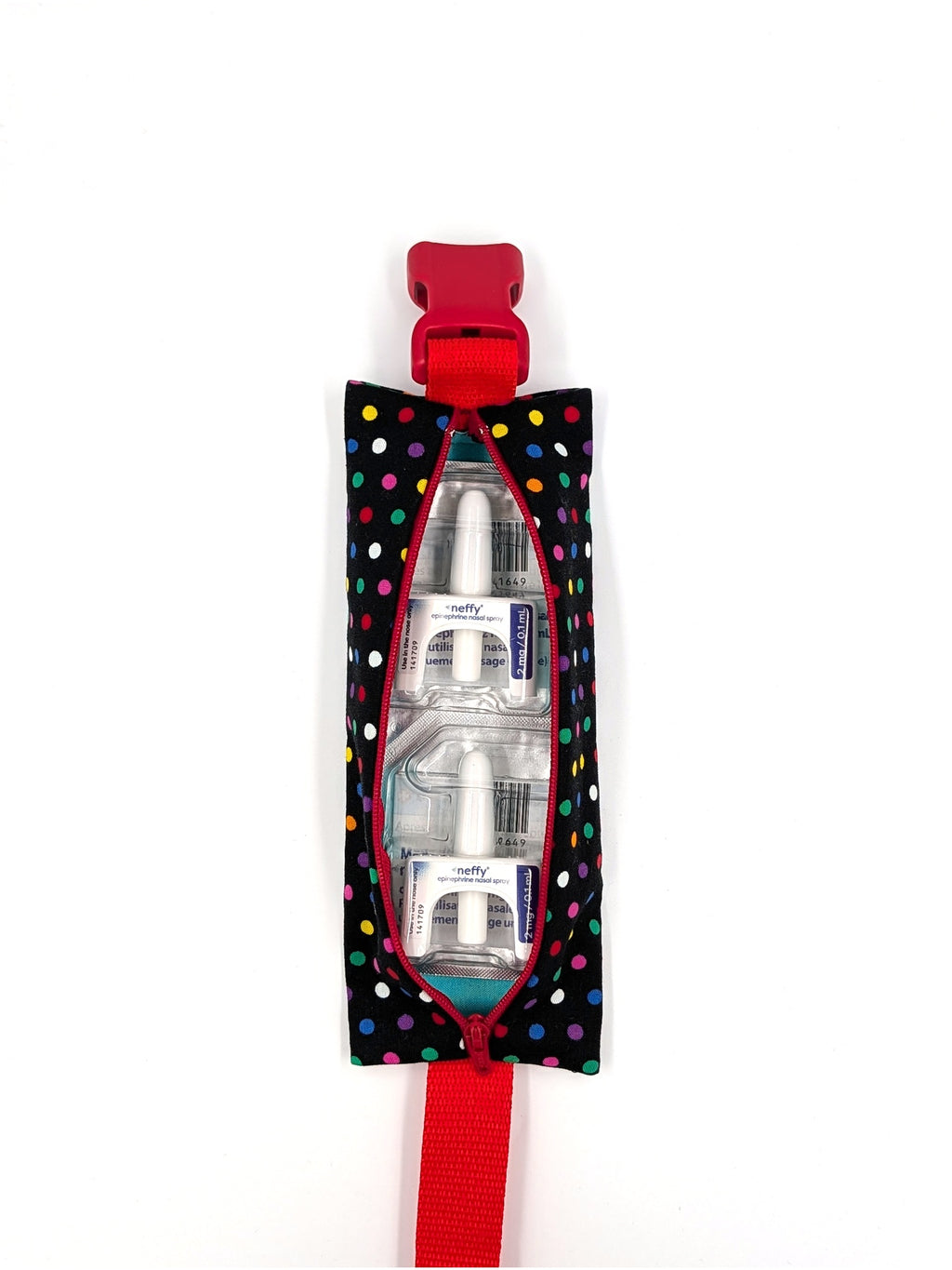 The Daydreamer EpiPen pouch in a black confetti dot print with the red adjustable belt, open with two neffy nasal spray doses inside