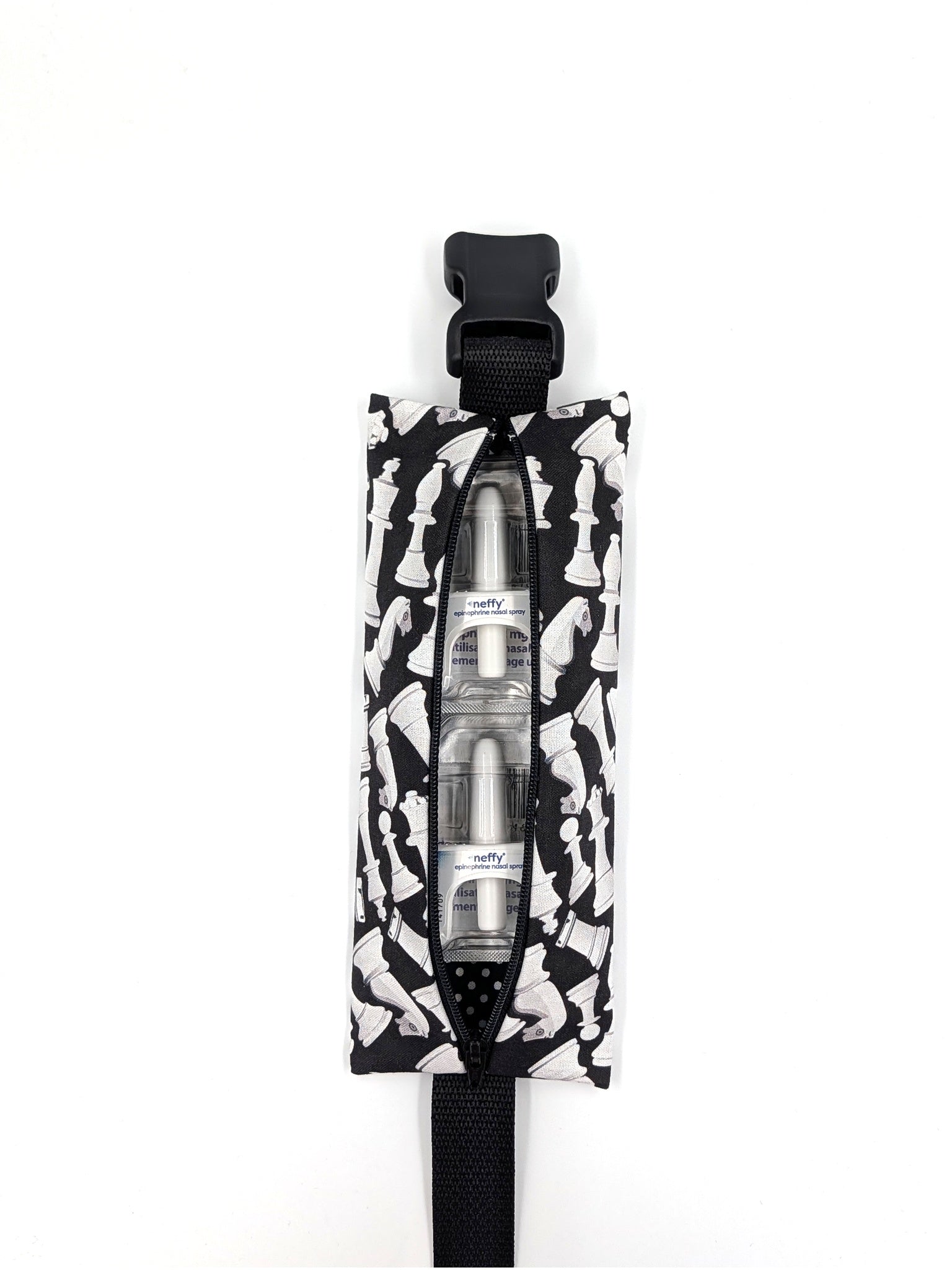 The Grand Master EpiPen pouch in a black and white chess print, open with two neffy nasal spray doses inside