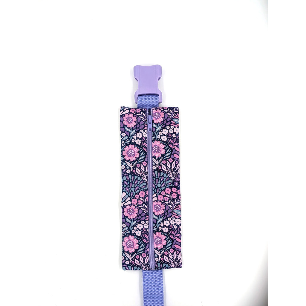 The Poet EpiPen pouch in a navy floral print, closed, shown with its adjustable belt