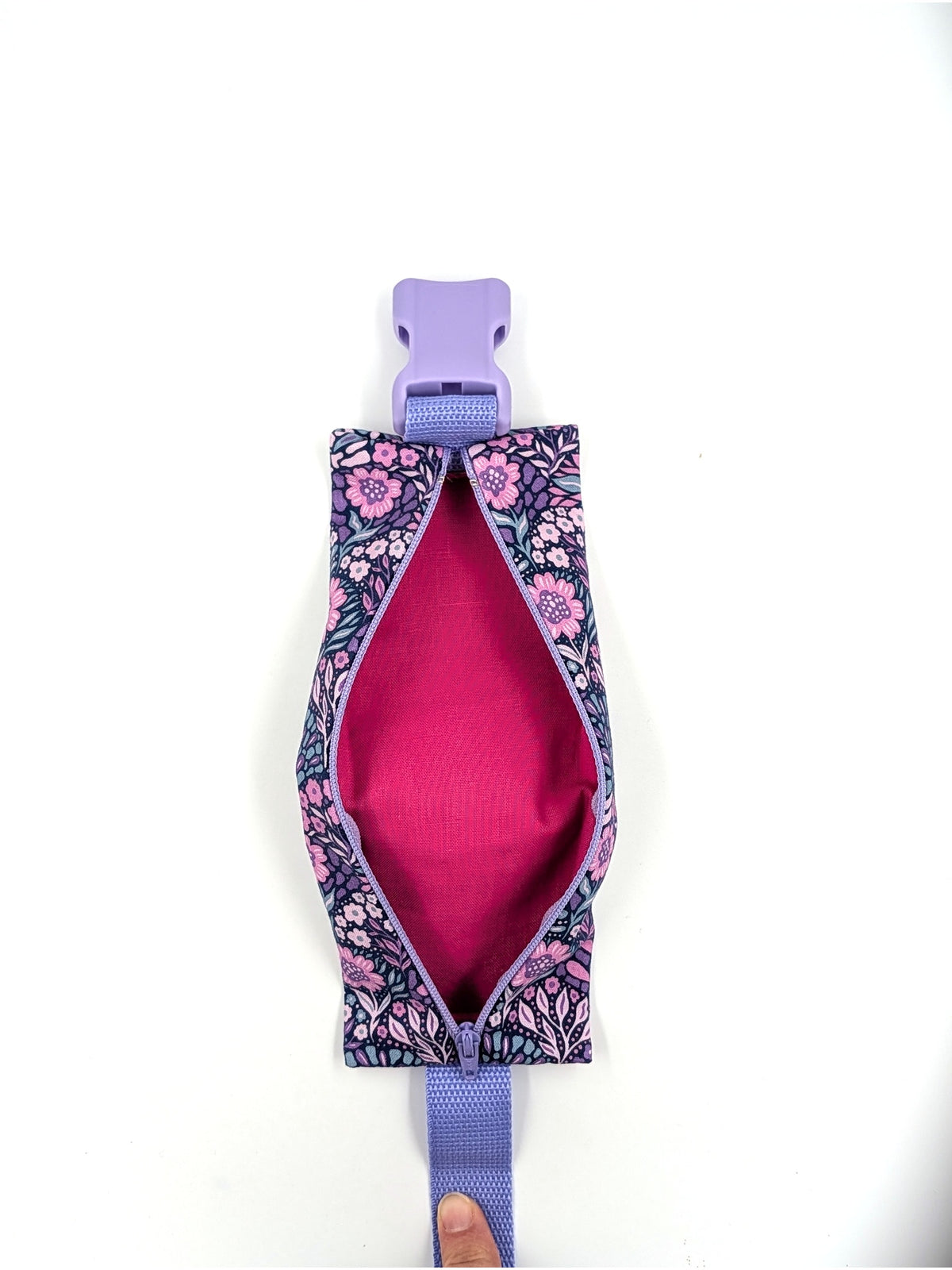 The Poet EpiPen pouch in a navy floral print, shown in use