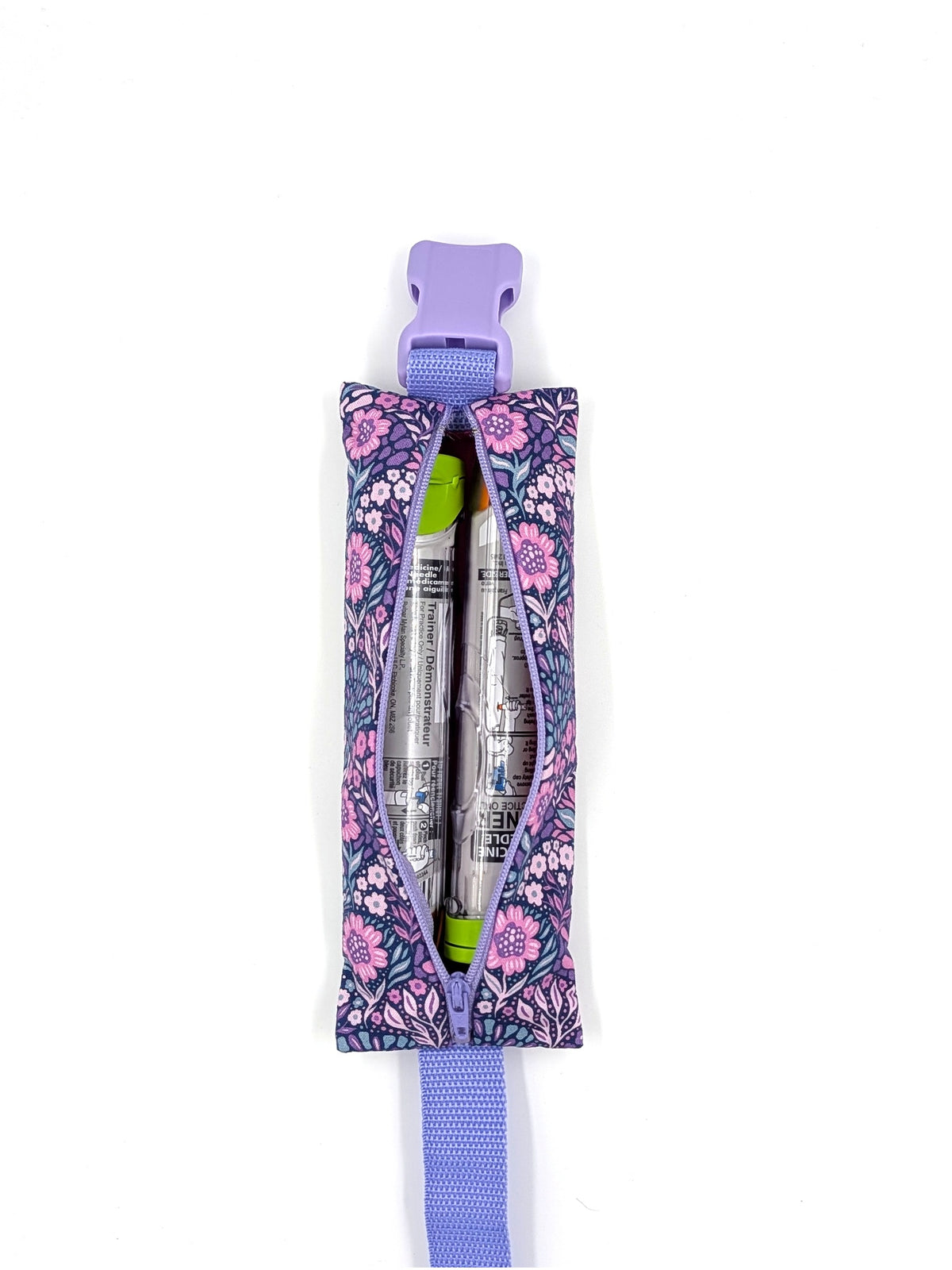 The Poet EpiPen pouch in a navy floral print, open with an auto-injector and an Emerade inside