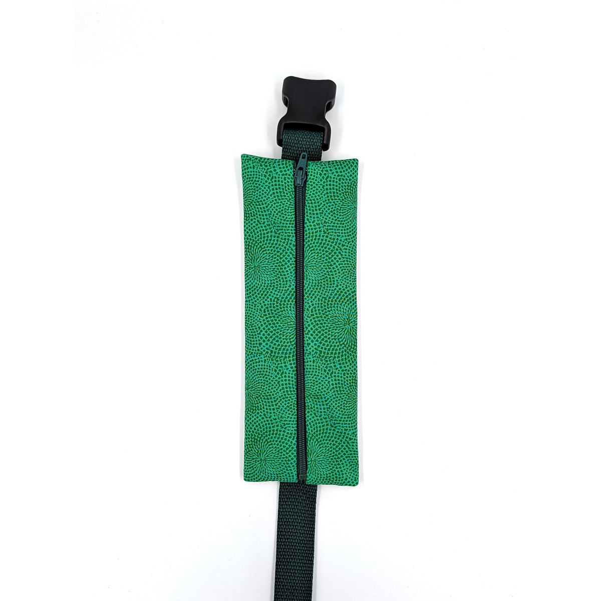 The Scout EpiPen pouch in an emerald green starburst print, closed, shown with its adjustable belt