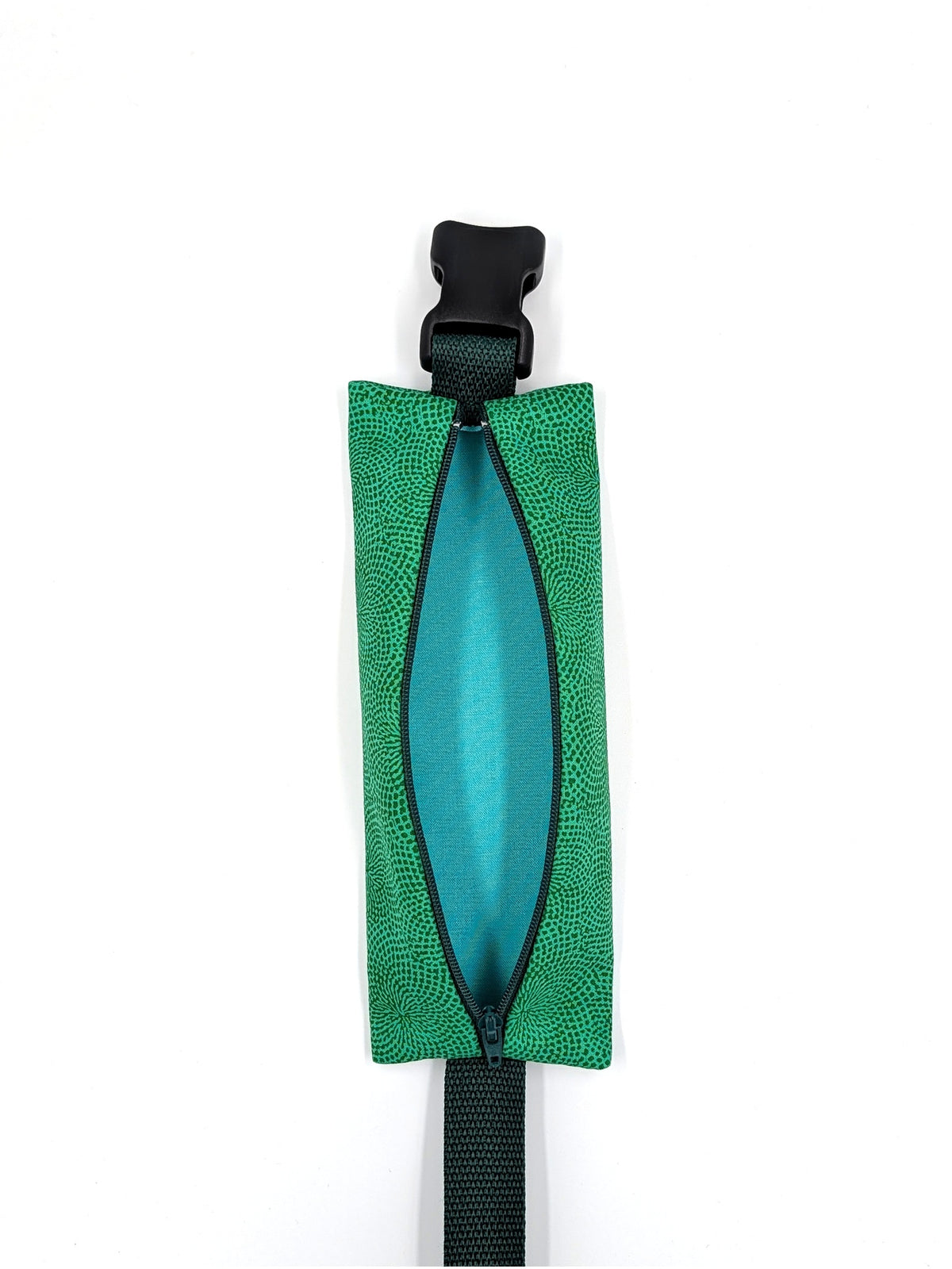 The Scout EpiPen pouch in an emerald green starburst print, unzipped and empty, showing the interior liner