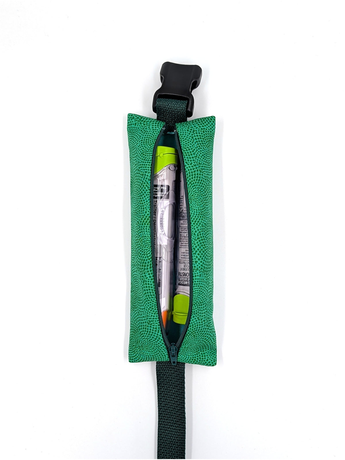The Scout EpiPen pouch in an emerald green starburst print, open with two EpiPen auto-injectors inside