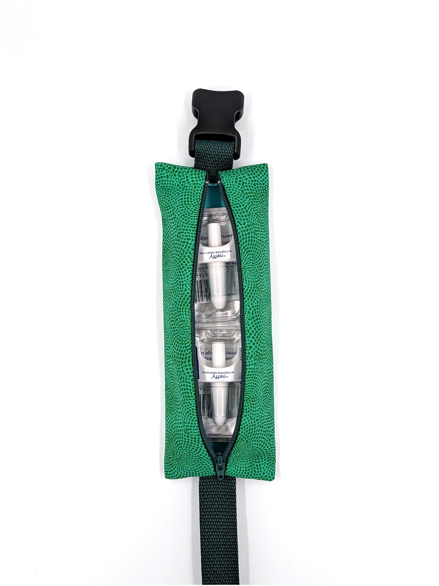 The Scout EpiPen pouch in an emerald green starburst print, open with two neffy nasal spray doses inside